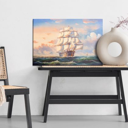 Canvas print Sailing ship on the sea under a pastel sky